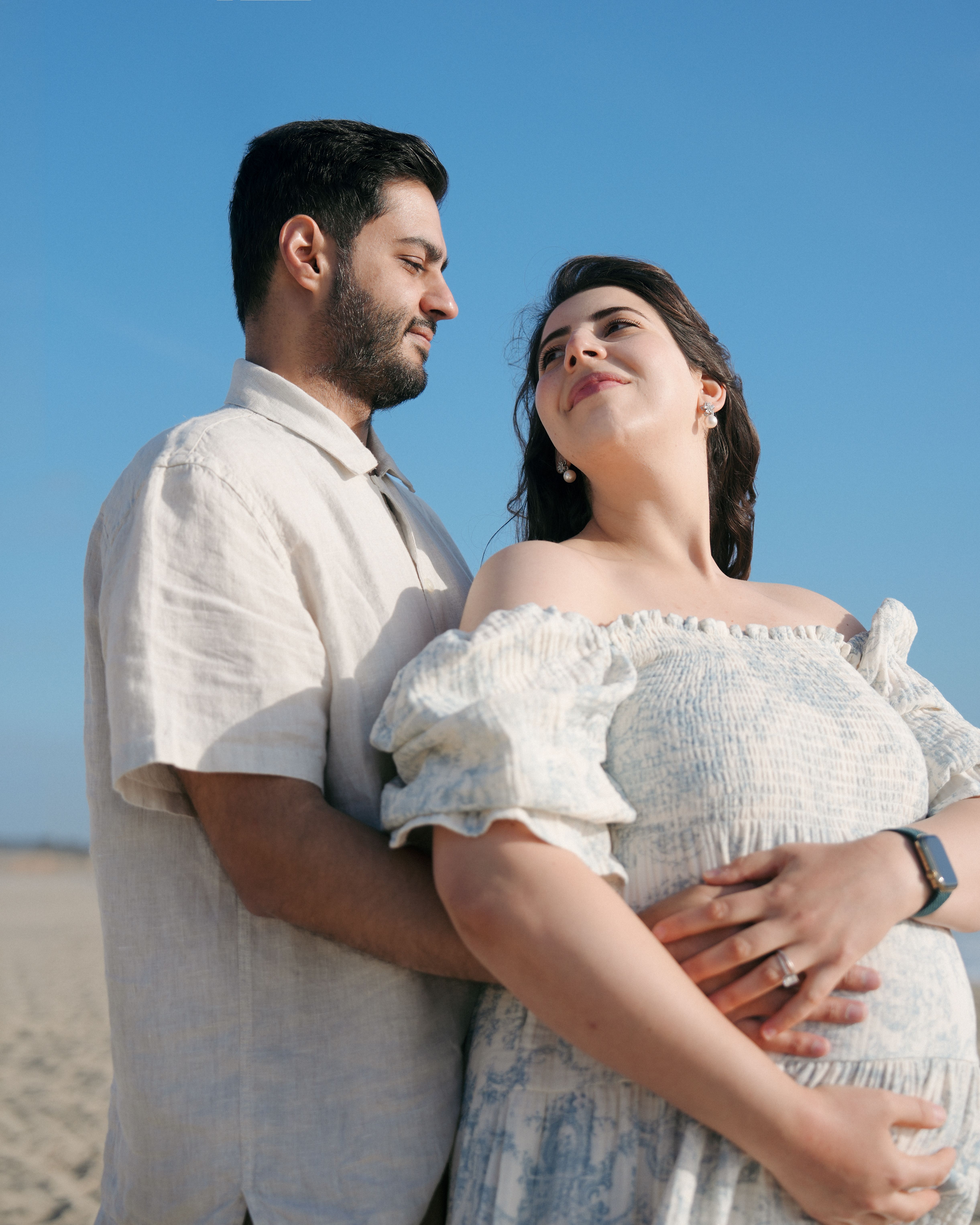 Leaning maternity pose at a beach overlook near Brisbane, California