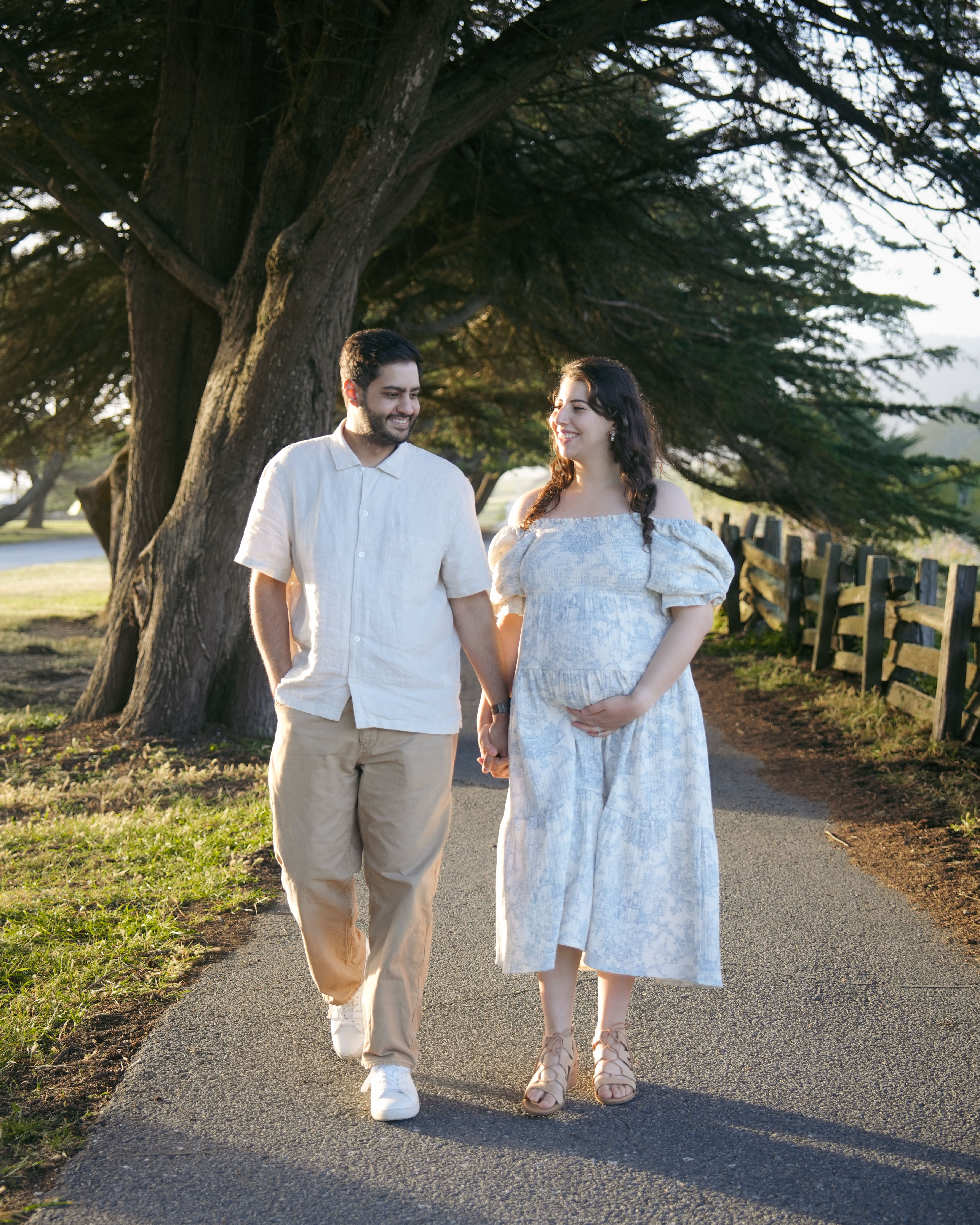 Maternity couple walking a cypress path in Mill Valley, California