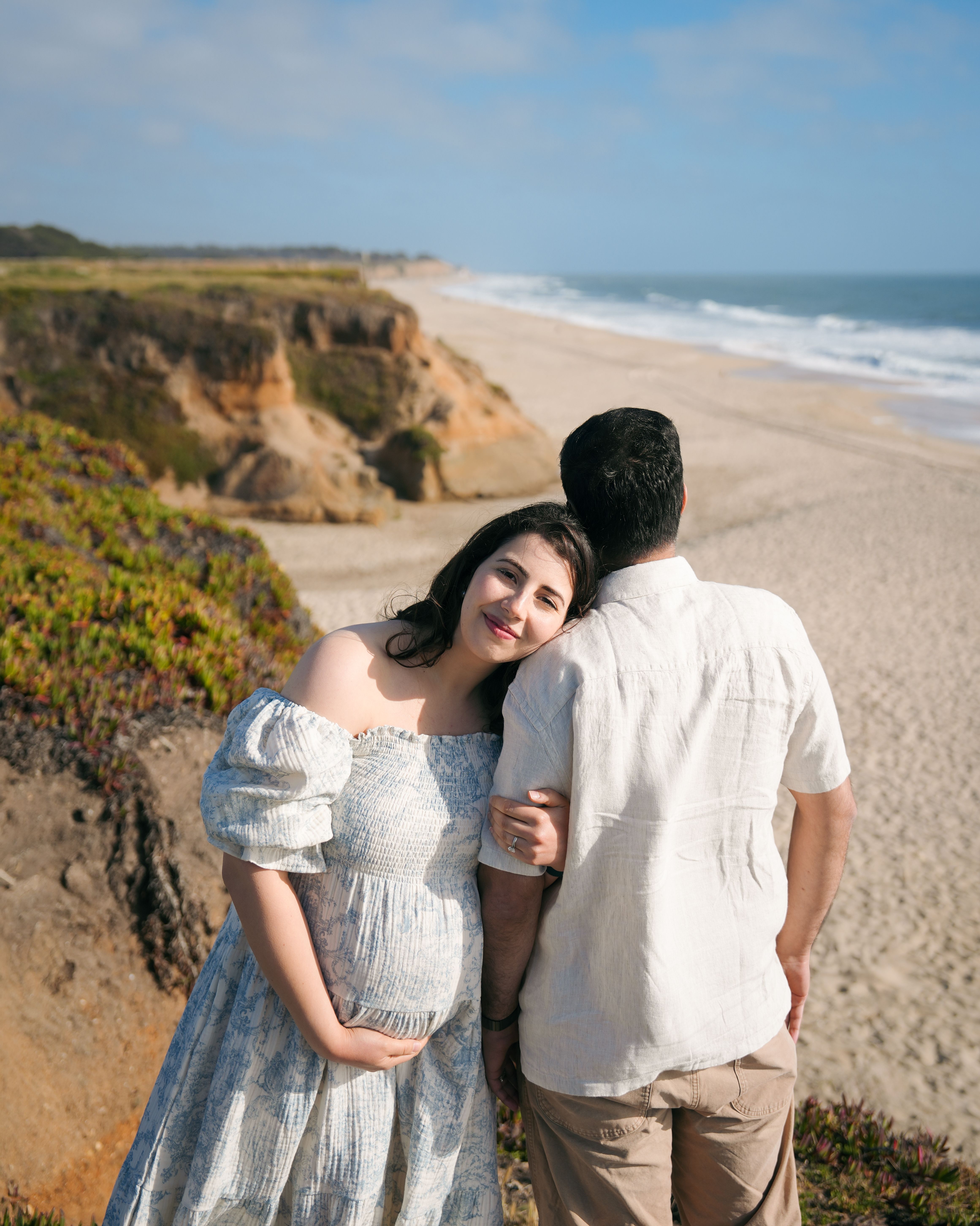Maternity couple embracing on Pacifica cliffs, California