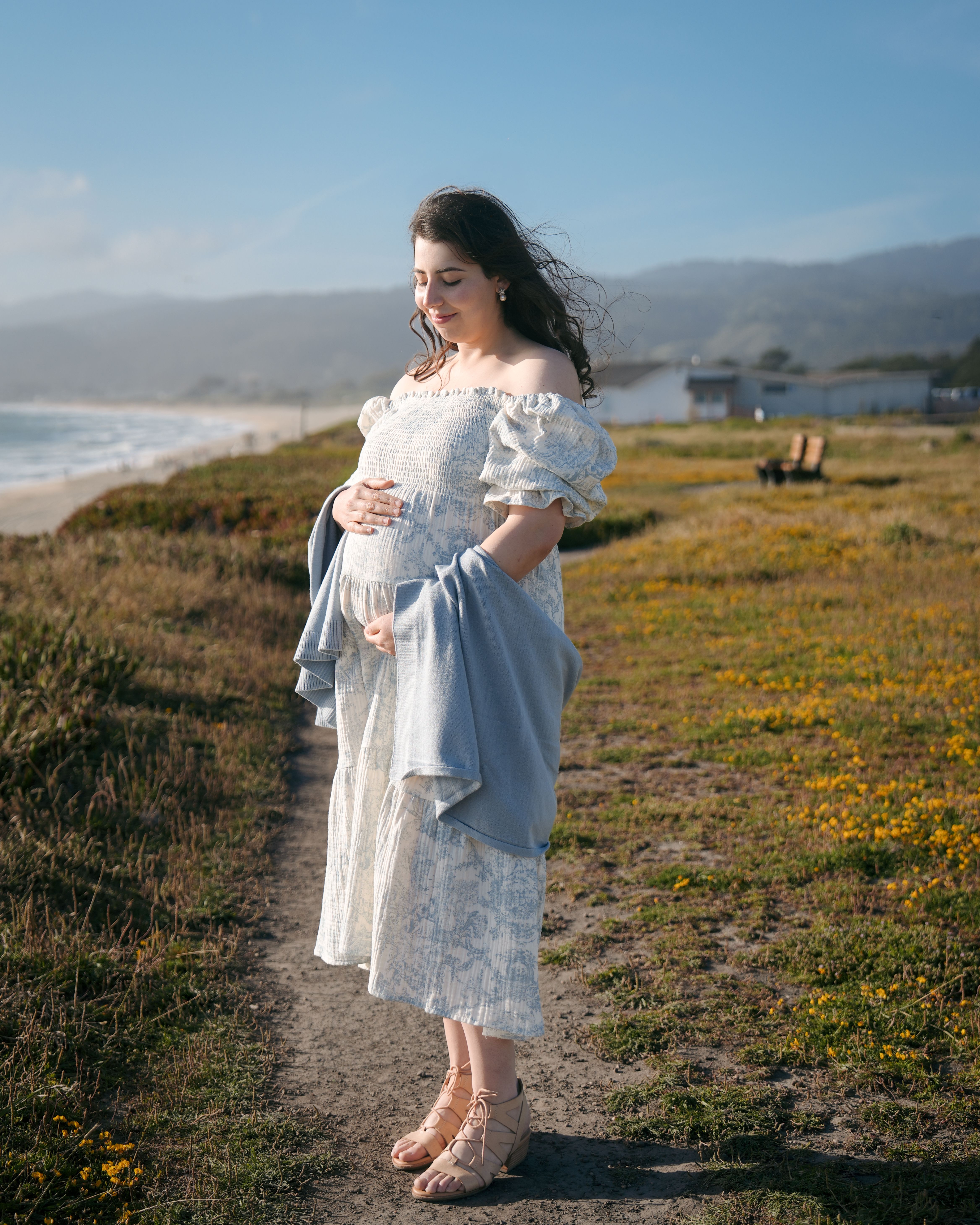 Maternity couple walking a coastal trail in San Gregorio, California