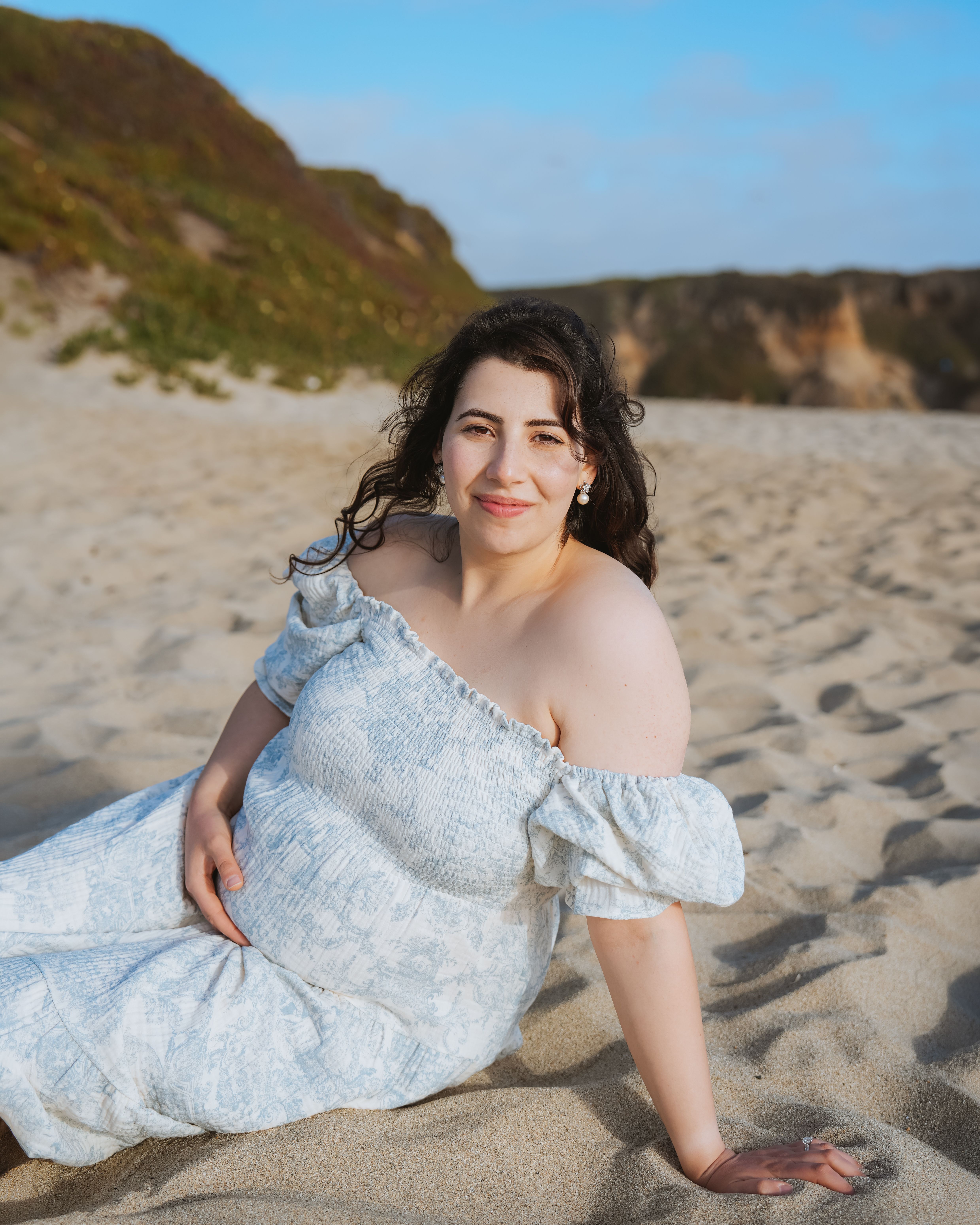 Maternity couple embracing on a cypress path in Alameda, California