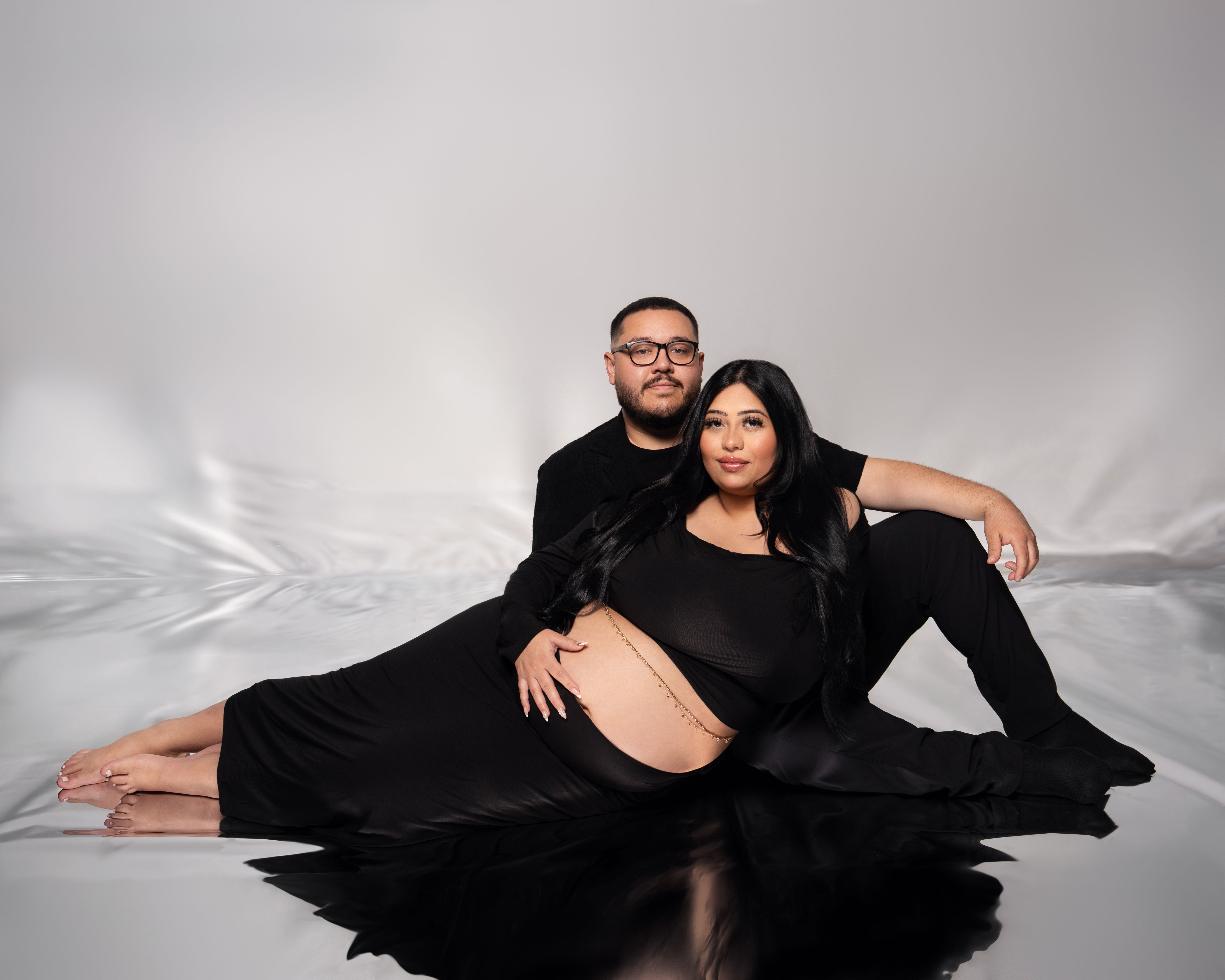 Standing maternity couple gazing together in Belmont, California