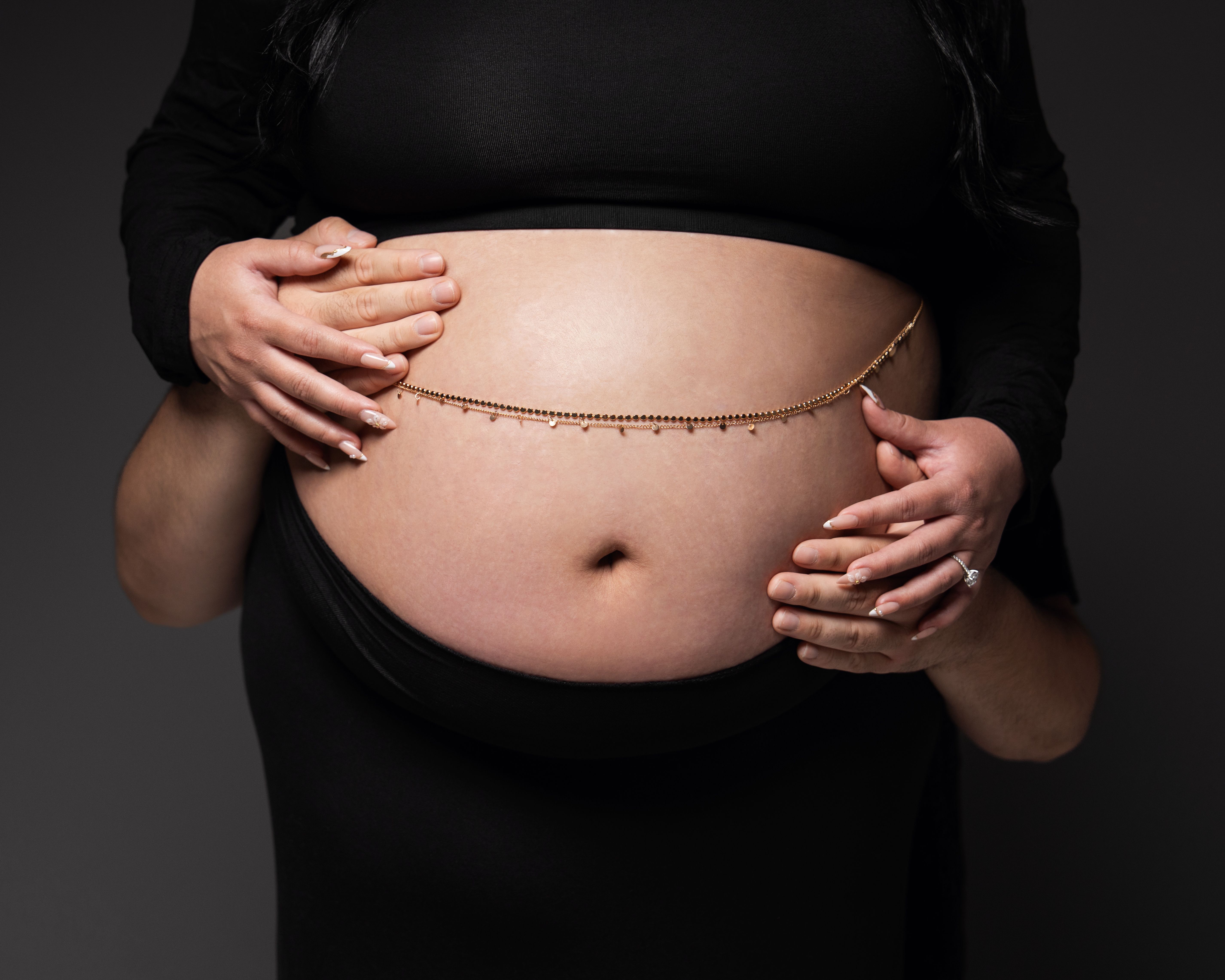 Standing maternity portrait against a white backdrop in Palo Alto, California