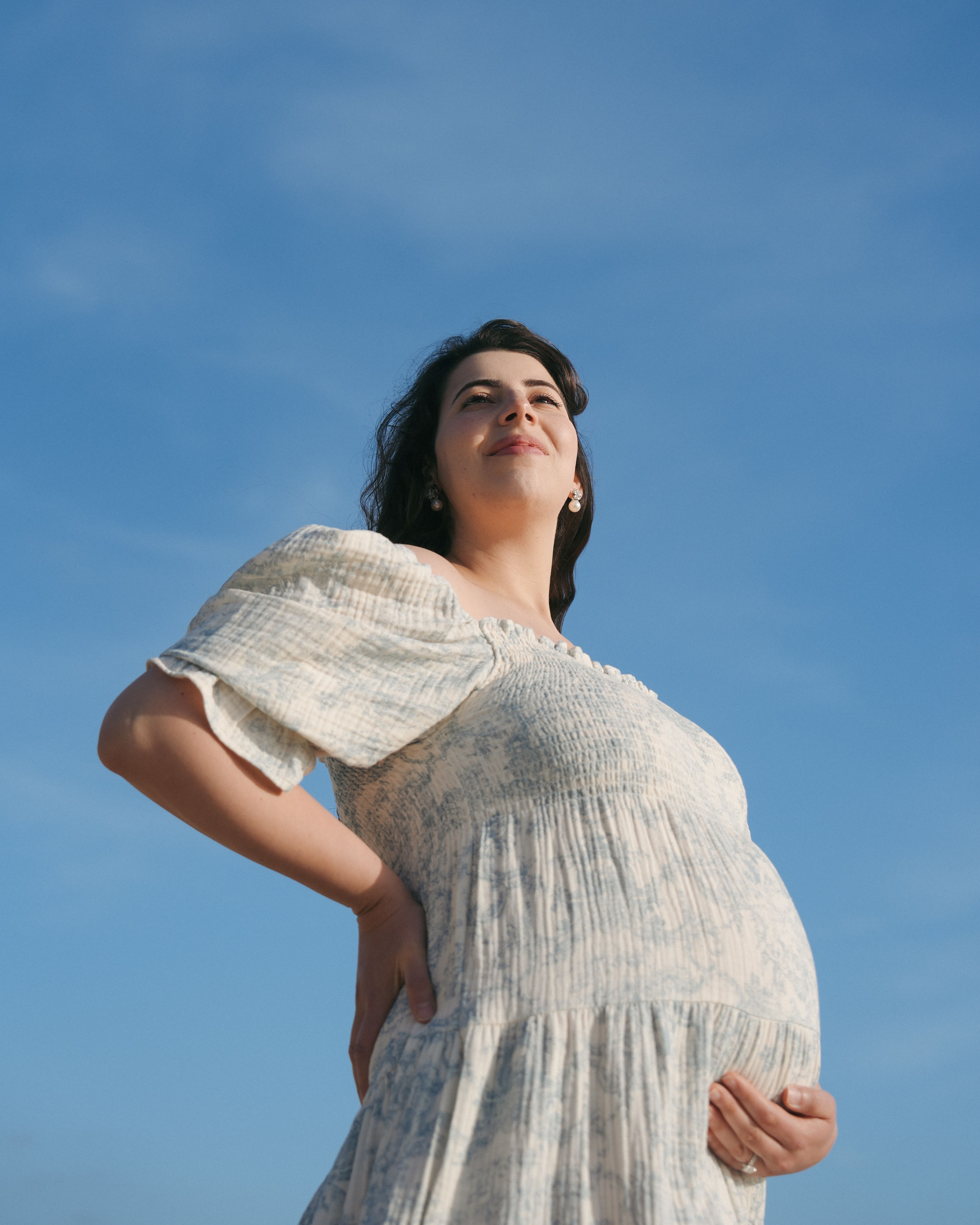 Seaside baby bump embrace in Mill Valley, California